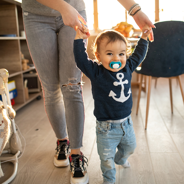 Happy baby boy learning to walk